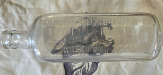 Antique glass embalming fluid bottle with "THE EMBALMERS SUPPLY CO WESTPORT. CONN embossed 